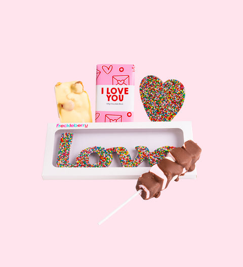 A gift box with an assortment of chocolate candies, including shapes such as a heart and a message block, with a 'I LOVE YOU' card on top.