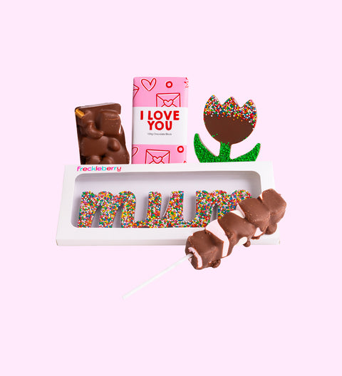 A gift box of various chocolates including a milk chocolate message block, milk chocolate rocky road, freckle tulip, mallow pop, and a chocolate shaped like the word 'Mum'.