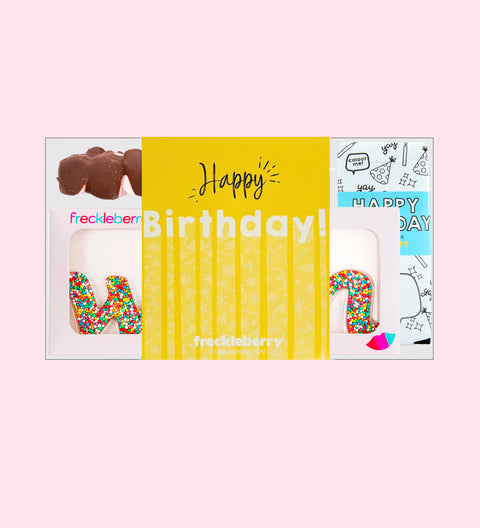 A gift box from Freckleberry Chocolate Factory featuring a Happy Birthday message, with a yellow background and decorated chocolate letters.