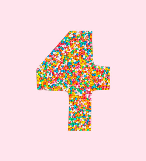 Belgian milk chocolate in the shape of the number 4, covered with multicolored sprinkles.