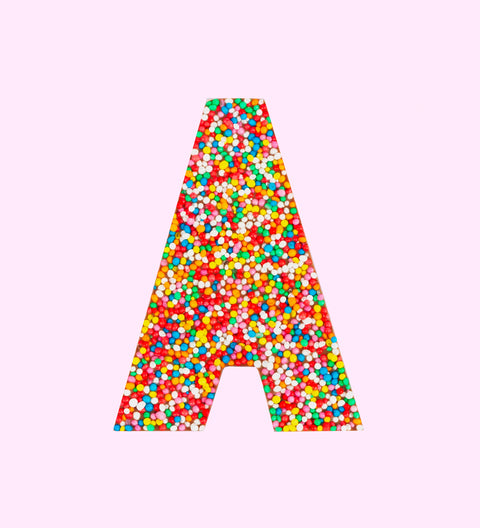A milk chocolate letter 'A' covered in multicolored sprinkles.