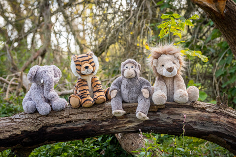Four stuffed animals (elephant, tiger, monkey, lion) sitting on a tree branch with a natural background. Buy in Geelong