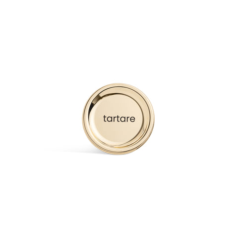A tall, cylindrical white bottle with a brushed gold label disc at the bottom and a precision squeeze nozzle on the side. Tartare sauce