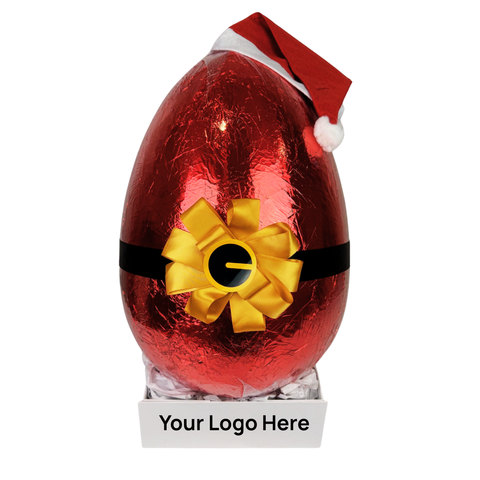 Red foil-wrapped chocolate egg with a yellow bow and Santa hat on a white background - add your corporate logo