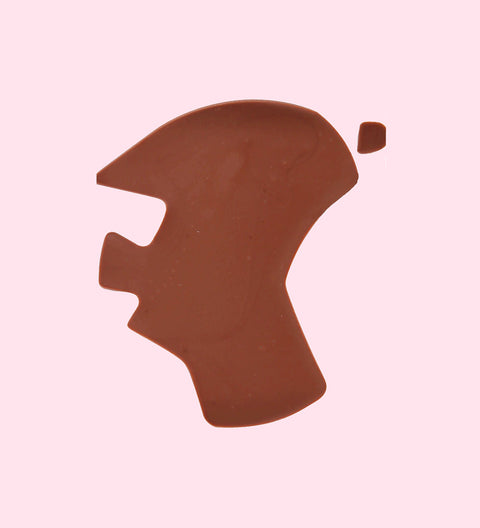 A chocolate piece in the shape of Australia map with multicolored sprinkles on it.
