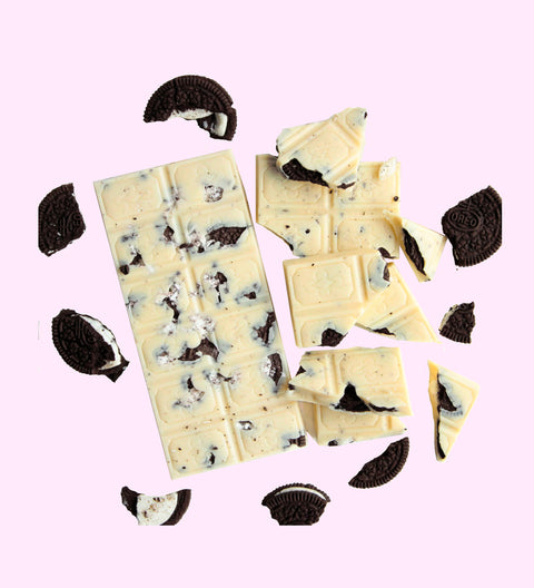 A white chocolate block with visible chunks oreo of dark chocolate, arranged on a white background.