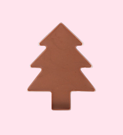A plain chocolate tree-shaped treat against a pink background.