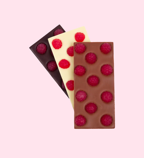 Assorted chocolate bars topped with chewy raspberry lollies, presented in a variety of white, milk, and dark chocolate.