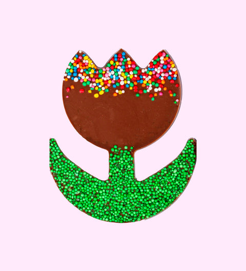 A chocolate tulip-shaped candy with multicolored sprinkles on top and a green glittery base.