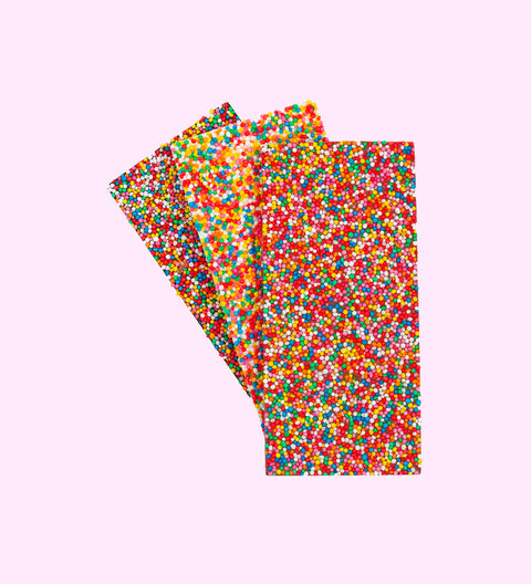 A chocolate block with a 'MUM' text and floral design on it, presented next to its packaging which has a similar design.