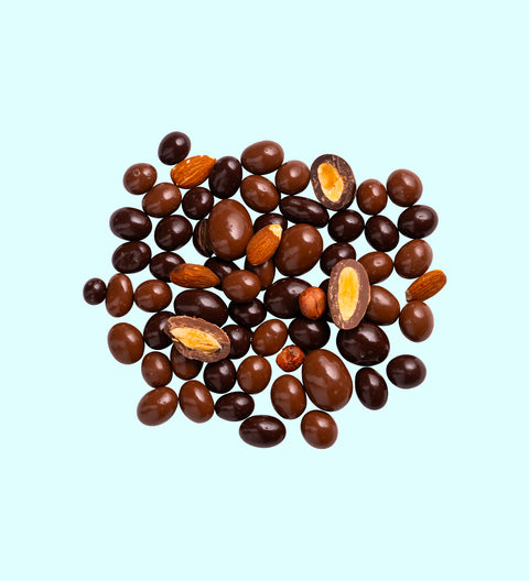 A variety of chocolate covered fruits and nuts mixed together.