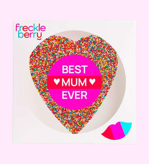 A large heart-shaped chocolate with multicolored sprinkles and 'BEST MUM EVER' text in the center.