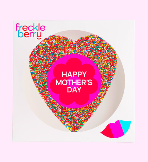 A large heart-shaped chocolate with multicolored sprinkles and 'BEST MUM EVER' text in the center.