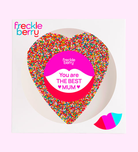 A large heart-shaped chocolate with multicolored sprinkles and 'BEST MUM EVER' text in the center.