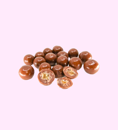 A group of milk chocolate coated ginger pieces