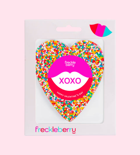A heart-shaped chocolate covered in multicolored sprinkles with a 'Be My Valentine' message in the center.