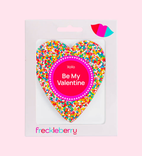 A heart-shaped chocolate covered in multicolored sprinkles with a 'Be My Valentine' message in the center.
