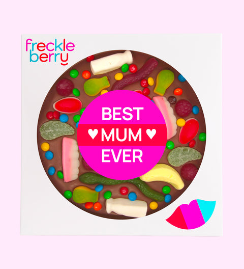 A giant chocolate pizza with various lolly toppings, including candies and gummy bears, with a 'Happy Mother's Day' message in the center.