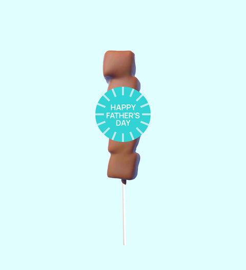 A marshmallow lollipop with a chocolate drizzle on a stick, labeled 'BEST DAD EVER'.