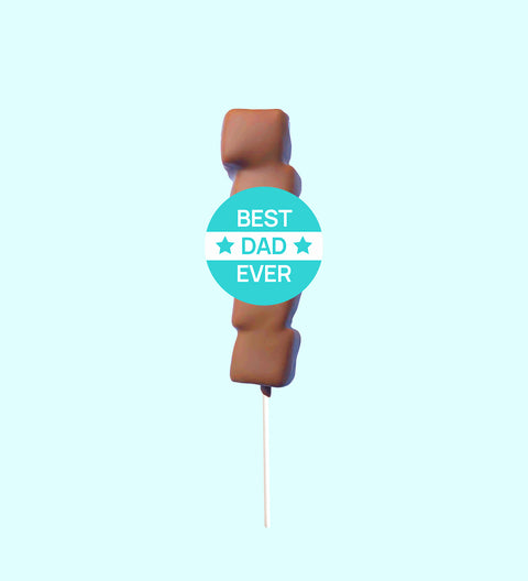 A marshmallow lollipop with a chocolate drizzle on a stick, labeled 'BEST DAD EVER'.