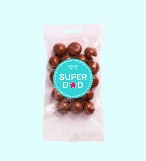 A clear plastic packaging containing milk chocolate coated raspberries with a 'Happy Father's Day' sticker on the front.