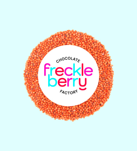 A clear plastic sleeve containing orange colored freckles.