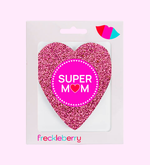 A pink freckle heart-shaped chocolate with a 'SUPER MOM' text in the center on a white background.