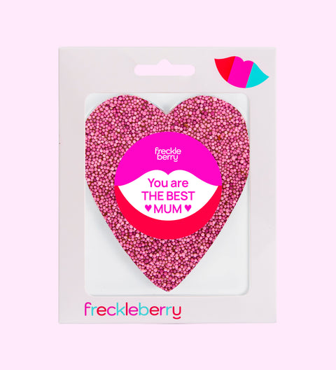 A pink freckle heart-shaped chocolate with a 'SUPER MOM' text in the center on a white background.