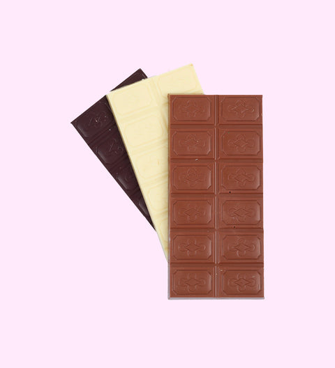 A chocolate block with a 'MUM' text and floral design on it, presented next to its packaging which has a similar design.