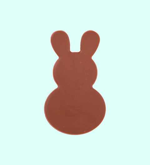 Milkchocolate bunnies in different shades of brown, beige, and dark chocolate, arranged side by side against a white background.