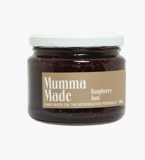 Jar of raspberry jam with 'Mumma Made' label on a white background