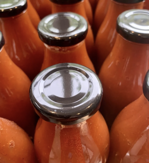Close-up of glass bottles with metal caps in a row