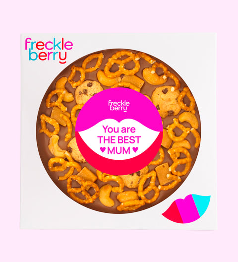 A snack large chocolate pizza with pretzels, chocolate chips, and nuts, topped with a 'You are the best mum.