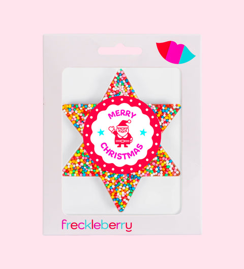 A packaged chocolate star shaped with 'Merry Christmas' text and colourful sprinkles design, branded 'freckleberry'.