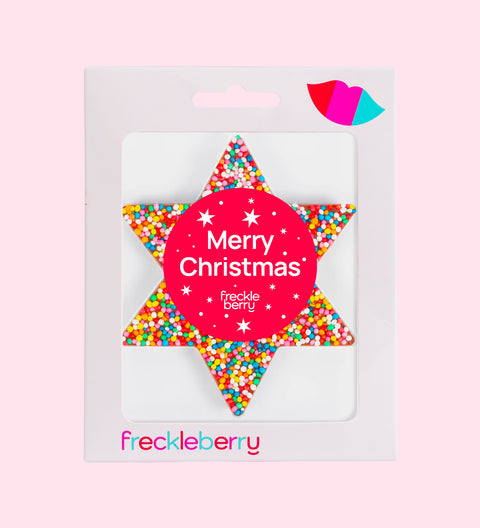 A packaged chocolate star shaped with 'Merry Christmas' text and colourful sprinkles design, branded 'freckleberry'.