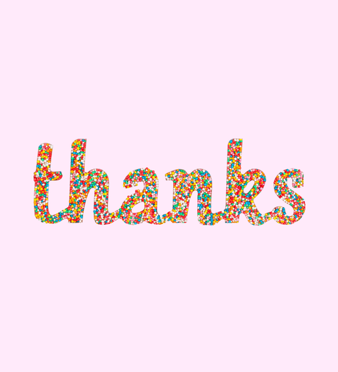 A colorful chocolate freckle in the shape of the word 'thanks' made from Belgian milk chocolate, covered with sprinkles.