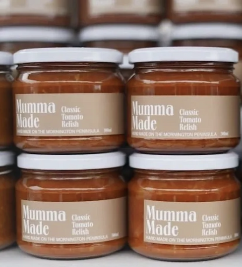 Four jars of Mumma Made Classic Tomato Relish on a white surface with blurred background