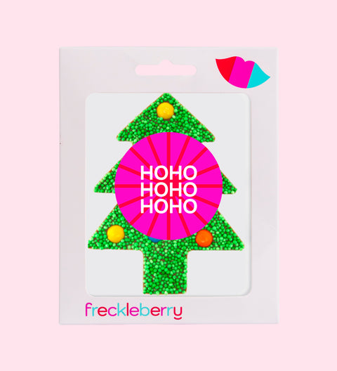 Packaged Christmas-themed green freckle M&M chocolate in the shape of a tree with a 'Merry Christmas' message, adorned with colorful sprinkles.