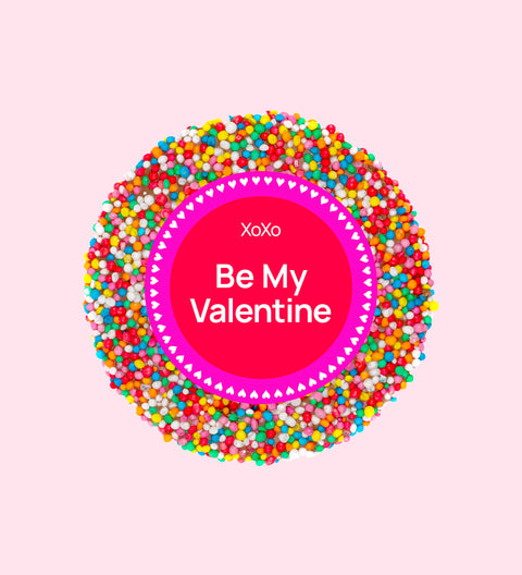 A colorful chocolate freckle with a 'Be My Valentine' message in the center.