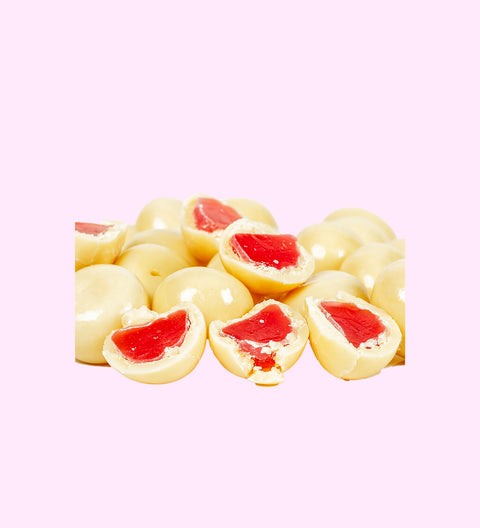 White chocolate coated raspberries with visible red raspberry filling