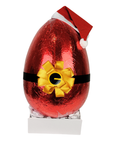 Huge 6kg Christmas egg. Red foil-wrapped chocolate egg with a yellow bow and Santa hat on a white background