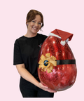 A luxurious Belgian milk chocolate santa egg wrapped in vibrant red foil packaging, perfect for an indulgent and show-stopping Christmas gift.