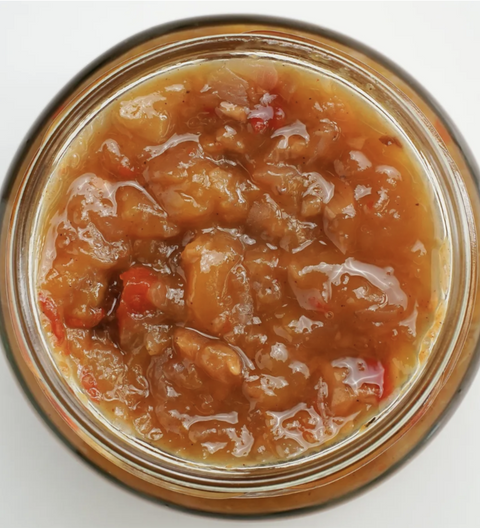 Jar of chunky fruit preserve mango