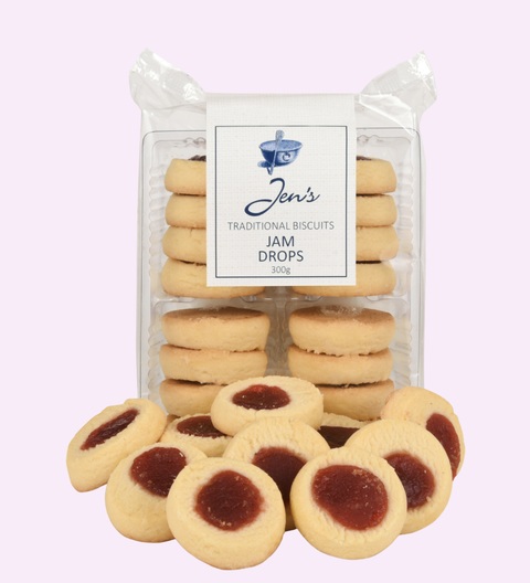 Packaged biscuits with jam drops on a light purple background