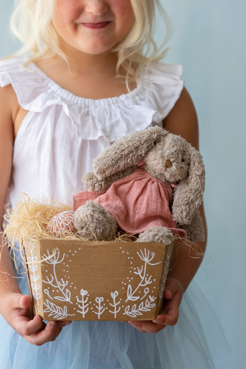 Young girl with a cheeky little plush with a sweet tooth and a love for honey-filled adventures. A soft, cuddly companion perfect for babies, kids, and thoughtful gifting.