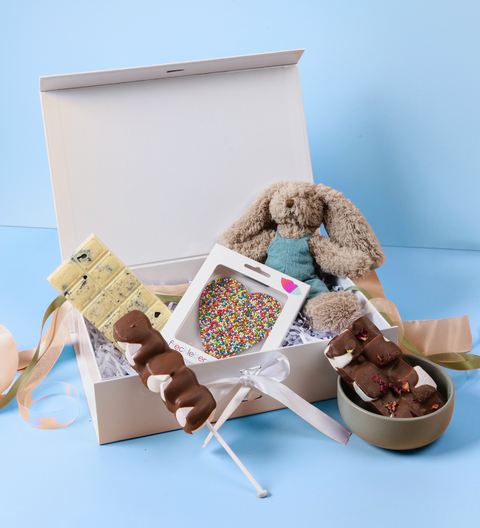 An indulgent selection of premium Belgian chocolates and blue bunny plush toy, customised for festive gifting to celebrate the coming of a new member of the family.