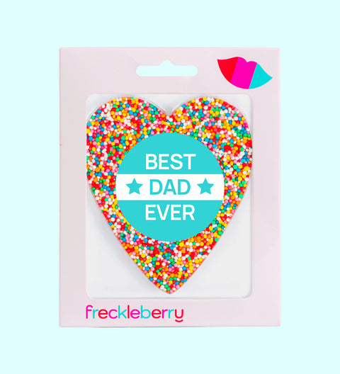 A heart-shaped chocolate with 'HAPPY FATHER'S DAY' written in the center, surrounded by colorful sprinkles. The product is packaged in a box with the brand name 'freckleberry' at the bottom.