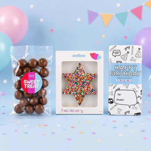 Star-shaped gift with colorful sprinkles in a clear package with premium chocolate block, and bag of milk coated raspberries