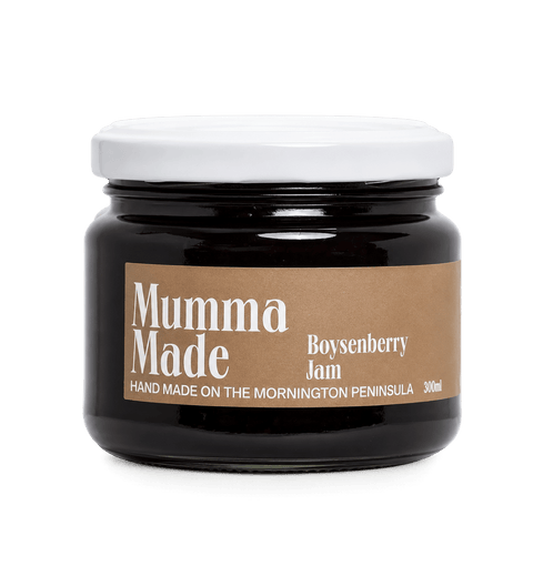 A 300ml glass jar of Mumma Made Boysenberry Jam with a white lid and a brown kraft paper label, set against a solid dark green background.