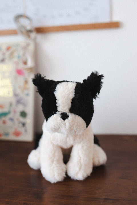 A soft plush dog toy with a charming personality and refined style. Perfect for babies, kids, and comforting cuddles.